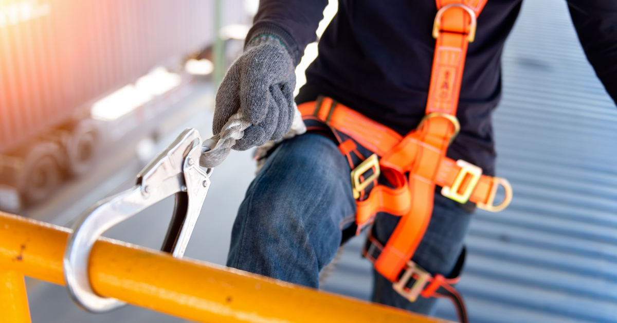 worker with harness on industrial building roof